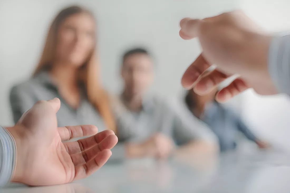 personal-perspective-view-speakers-hands-gesturing-with-pen-business-meeting-table