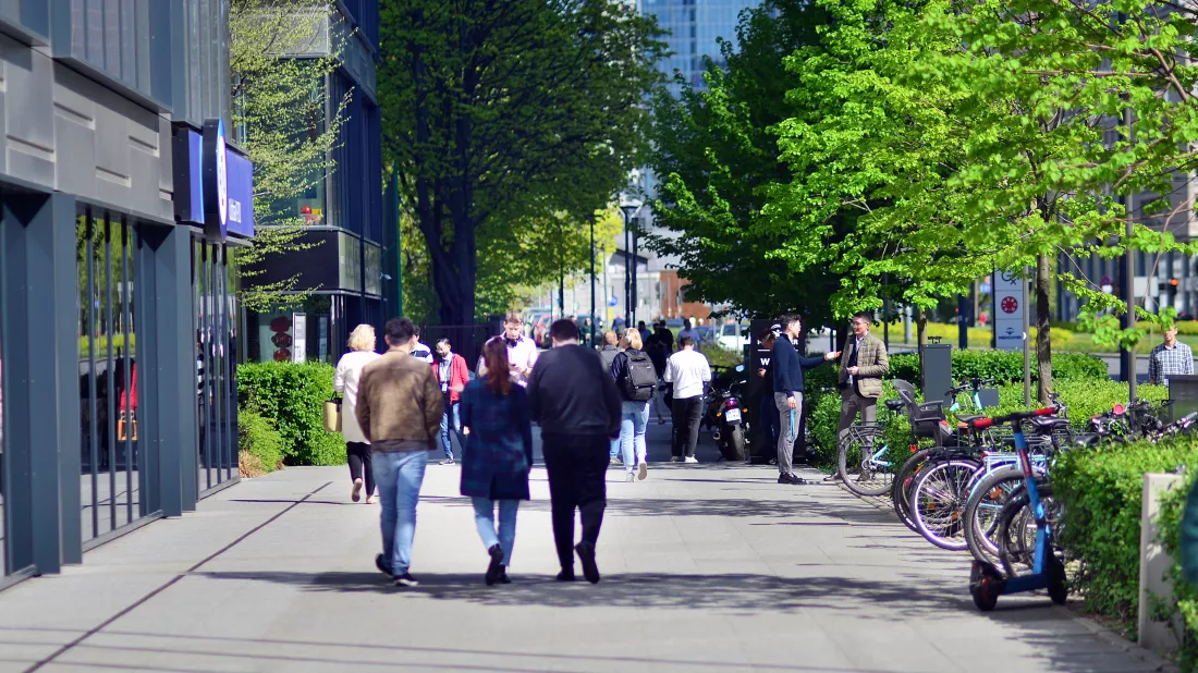 group-people-walk-down-sidewalk-one-which-has-bicycle-it