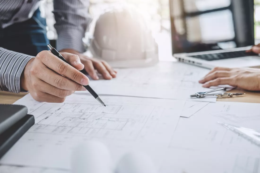 midsection-architect-working-blueprint-table